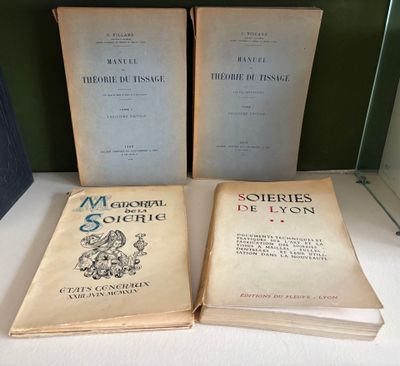 two old books sitting on top of a table next to each other