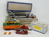a lot of toy cars and trucks on a white surface