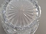 a clear glass container with a circular design on it