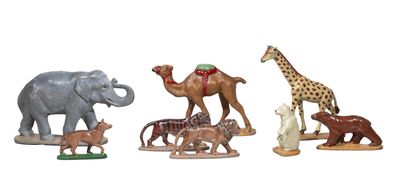 several figurines of different animals are shown on a white surface