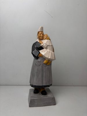 figurine of a woman holding a baby in her arms