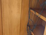 a wooden cabinet with a surfboard on top of it