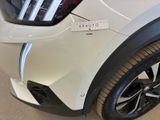 a close up of a white car with a sticker on it