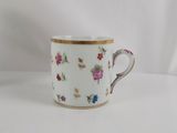 an image of a coffee cup with flowers on it on a white surface