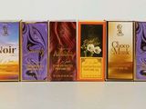 five boxes of perfumes sitting on a table