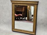 a reflection of a person in a mirror on the wall