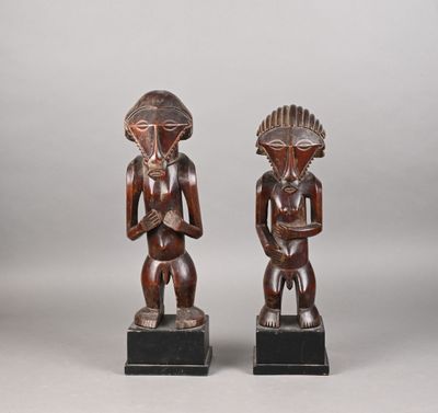 a pair of carved wooden figures of a man and woman