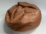 a brown bean bag sitting on a white table
