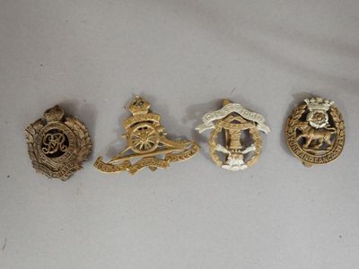 four badges of various sizes and shapes on a white surface