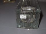 a glass bottle with a label on it sitting on a table