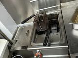 a small kitchen with a deep fryer and a sink