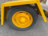 a yellow wheel on the back of a yellow truck