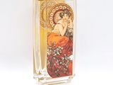 a glass vase with a picture of a woman on it