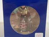 figurine of a man riding a horse in front of a blue box
