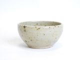 a white bowl that has a brown spot on the inside of it