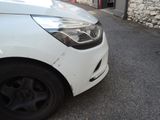 a white car that is parked on the side of the road