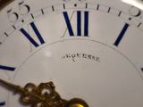 a close up of a clock with roman numerals on it