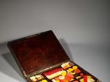 a small wooden box with many different types of candies in it