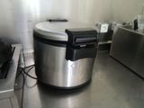 stainless steel counter top in a commercial kitchen with an electric cooker
