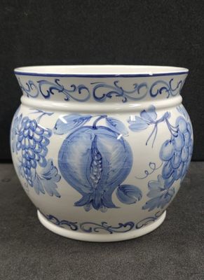 a blue and white vase with a fish design on it