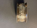 a close up of a silver ring with a design on it