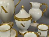 a white and gold tea set with gold trims
