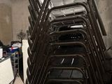 a lot of chairs that are stacked up in a room