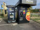 a black box with a pizza on it in a parking lot