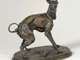 bronze statue of a dog on a base with a ball in its mouth