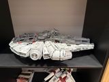 lego star wars millennium fighter on display in a bookcase