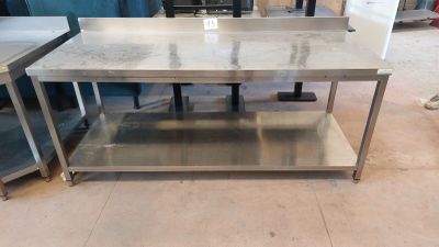 une table en acier inoxydable avec un plateau en marbre dans une pièce