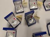 many different types of silver coins displayed in a display case