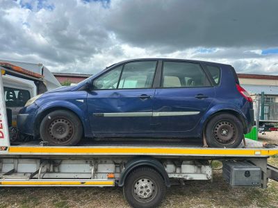 a blue car on the back of a flatbed truck