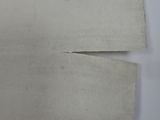 someone is holding up a piece of paper that has been cut in half