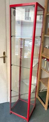 a glass display case in the corner of a room