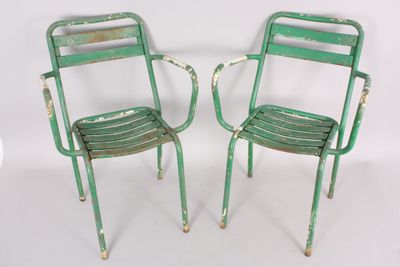pair of green metal chairs on white background with white background