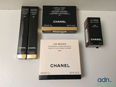 trois boîtes de maquillage Chanel posées sur une table, avec une boîte de rouge à lèvres