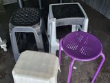 four stools and a table in the corner of a room