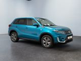the blue suv is parked in a room with a white wall