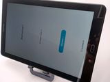 a tablet that is sitting on a stand on a table