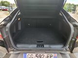 the back of a car with its trunk open and a license plate in the trunk