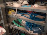 many different types of wires on the shelves in this room