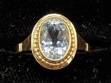 an image of a gold ring with a white diamond in it