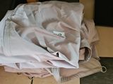 a pile of clothes sitting on the floor next to a red basket