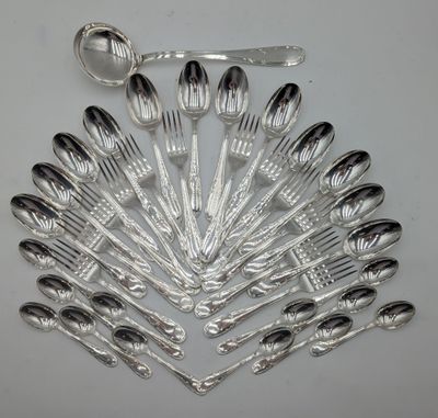 a lot of silver spoons and spoons on the table