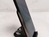 a cell phone that is on a stand on a table