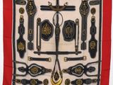 an image of a red scarf with a bunch of different items on it