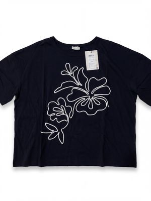 a black t - shirt with white flowers on it