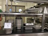 many pans and pans on the counter in the kitchen