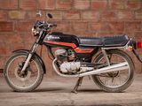 a motorcycle that is parked in front of a brick wall